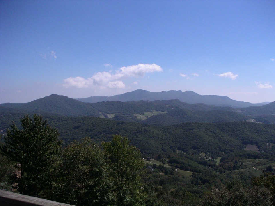 blue sky view of grandfather mountain, diamand creek golf course and banner elk valley