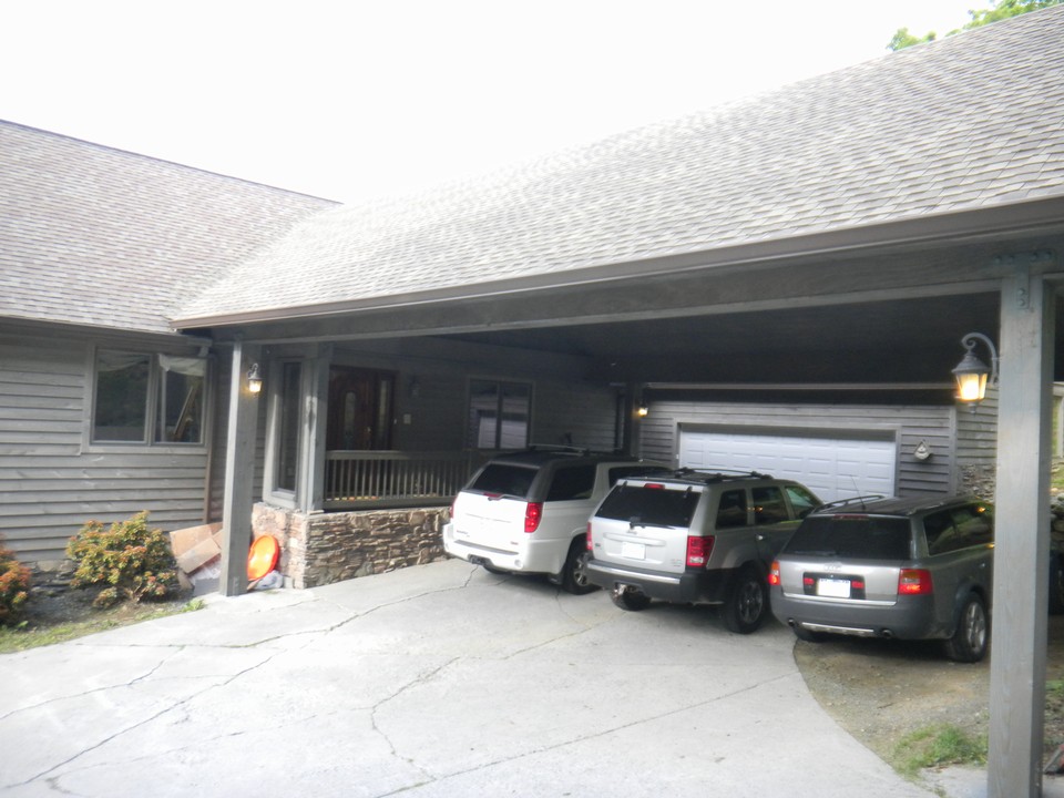 large carport protects entrance from  rain and snow!